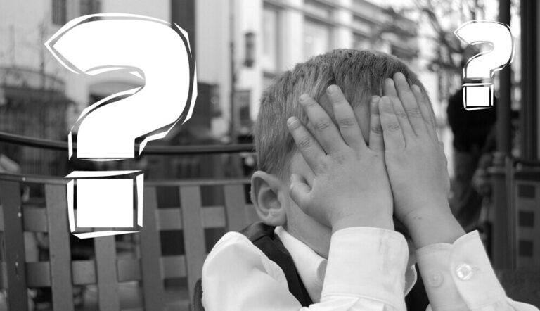 child with his hands over his face for making a mistake