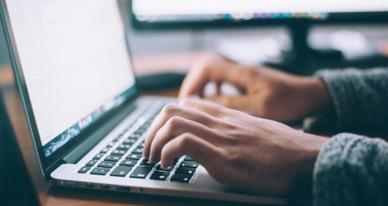 Typing on a laptop